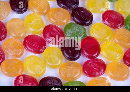 Vibrant multicolored candies in bulk display, retail shelf context, bulk purchase concept, texture contrast, shopper appeal, colorful selection Stock Photo