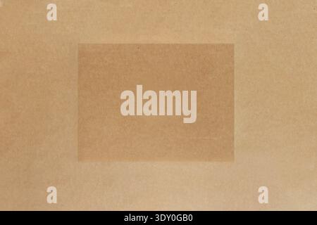 Top view of a rectangular frame on a textured recycled brown cardboard background with copy space Stock Photo