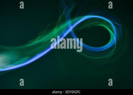 Dynamic blue green light trail swirling concept Stock Photo