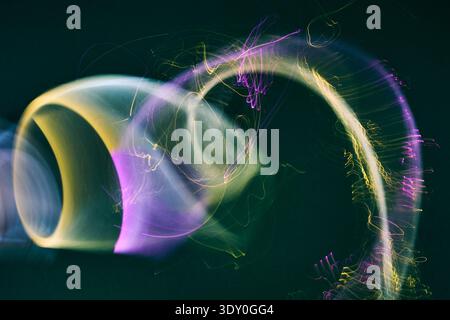 Abstract purple and yellow light trails creating motion Stock Photo