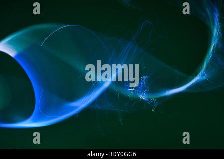 Abstract blue and green light painting creating motion blur Stock Photo