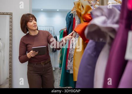 A designer uses a tablet in her store Stock Photo