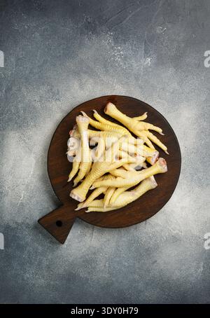 Raw fresh chicken feets for cooking Indonesian, thai, malaysian  and Chinese dishes. ceker. Selective focus, top view, copy space Stock Photo