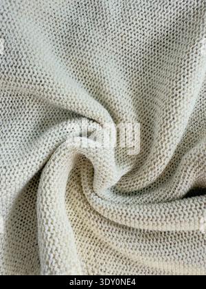 Sweater or scarf fabric texture large knitting. Knitted jersey background with a relief pattern. Wool hand- machine, handmade. Stock Photo