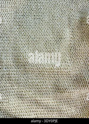 Sweater or scarf fabric texture large knitting. Knitted jersey background with a relief pattern. Wool hand- machine, handmade. Stock Photo