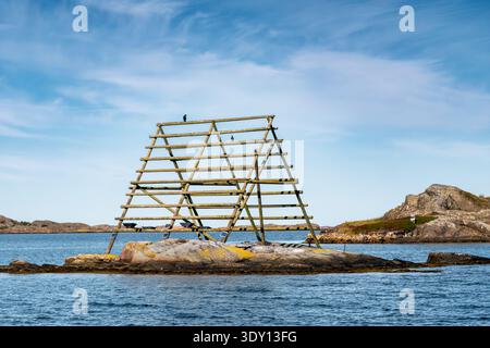 Traditional wooden fish drying rack on rocky islet near Fiskebäckskil, Bohuslän, west coast Sweden Stock Photo