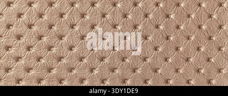 Light brown leather texture with capitone pattern, macro background of tan retro Chesterfield vintage textile fabric. Stock Photo