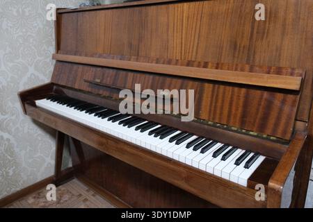 Vintage upright piano isolated on white background, front view Stock Photo