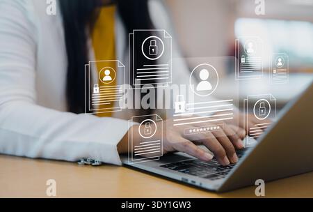 Businesswoman using laptop with cyber security icons and data protection interface for privacy, login credentials, and personal information safety in Stock Photo