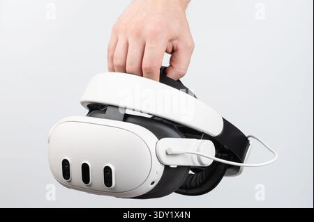 Virtual reality headset in hand close up view isolated on studio background Stock Photo