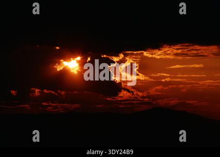 Scenic sunset over a horizon in Croatia. Sun behind clouds Stock Photo