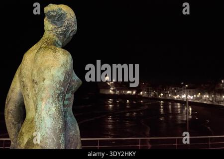Sitges. Spain - March 05, 2026: The statue Dona Mediterrania by Lluisa Granero in the foreground with the historic skyline of Sitges and the Mediterra Stock Photo