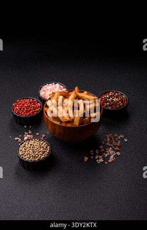 Croutons or crackers made from rye bread with garlic, salt, and spices, a salad ingredient. Croutons with salt and garlic as a food background for you Stock Photo