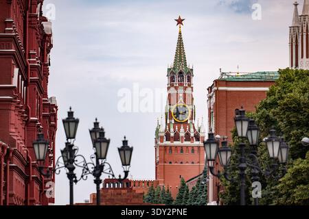 Spasskaya tower clock on Moscow Kremlin with Red Square buildings and street lanterns Stock Photo
