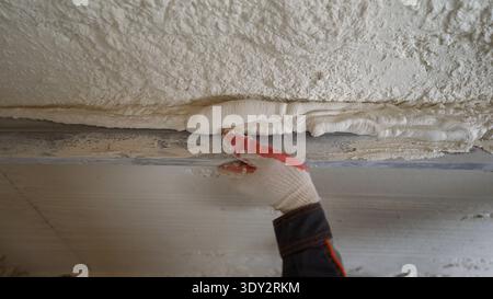 Worker Applying Plaster on a Wall Stock Photo