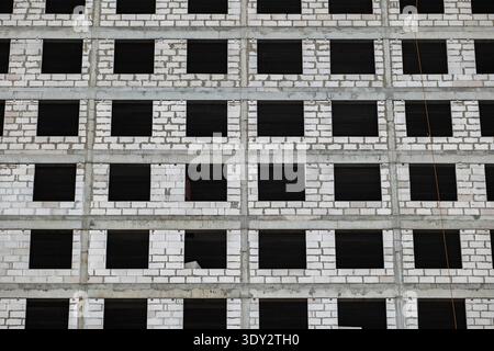 Modern building facade under construction with many windows and concrete structure Stock Photo