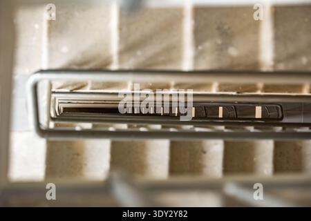 Looking down a well illuminated concrete stairway creating an abstract geometric pattern Stock Photo