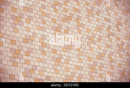 Modern building exterior featuring a diagonal pattern of beige and orange tiles Stock Photo