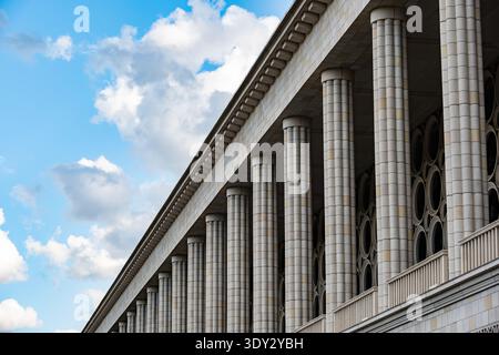 Architectural facade presenting symmetry and classical columns against a blue sky Stock Photo