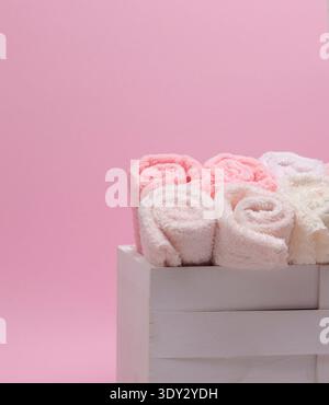 Stack of fresh towels on a light background, perfect for spa or hotel use, with space for adding self-care-related text. Stock Photo
