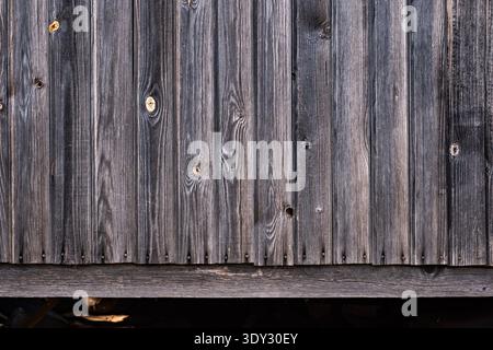 Weathered barn wood planks creating a rustic gray timber wall texture background Stock Photo