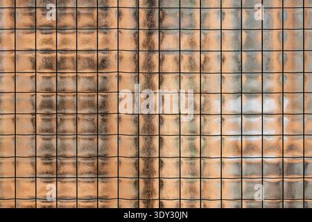 Wired glass panel creating abstract background texture with warm translucent light Stock Photo