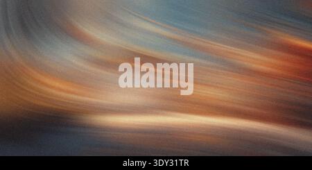 Abstract swirling brushstrokes of warm orange and cool blue hues create a dynamic and textured background with a luminous glow Stock Photo
