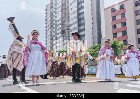 Dancers in traditional costumes participate in the joyful andean carnival parade Stock Photo