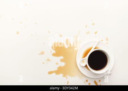 Coffee cup and spilt espresso on white background Stock Photo