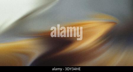 Abstract swirling patterns of golden brown and grey hues create a dynamic and energetic composition with a sense of motion and depth Stock Photo