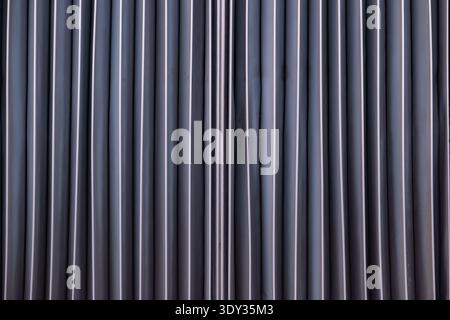 Abstract metal surface showing vertical lines and repeating industrial pattern Stock Photo