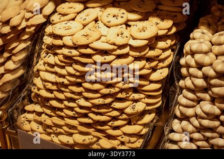 Delicious pile of assorted cookies displayed in a bakery setting. Stock Photo
