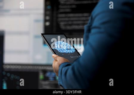 In a futuristic digital workspace, black developer programming software and explores code snippets. Tech professional embodies innovation, cybersecurity, automation and development. Stock Photo