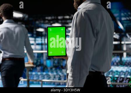 Close up of server hub admin using isolated display on tablet, reviewing AI LLM visualization on industrial platform. Developer using copy space device to monitor machine learning systems. Stock Photo