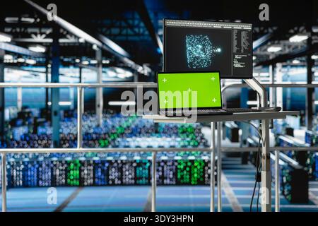 Isolated screen laptop with industrial data center control station monitor showing AI visualization. Chroma key computer in server farm displaying neural network diagnostics, supercomputers. Stock Photo