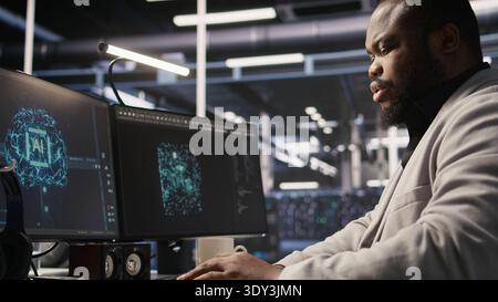 Cheerful data center admin pleased after finalizing neural network software build upgrade. Joyous server hub IT specialist smiling after seeing at stable infrastructure performance, camera A Stock Photo
