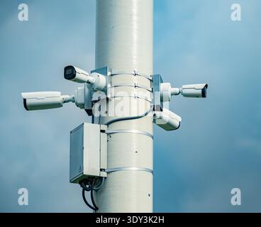 Multiple cctv cameras on a pole monitoring public spaces for security and safety Stock Photo