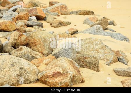 Granite stones and sand at the seaside. Nothing but granite stones and sand as far as the eye can see, a desolate and lifeless wasteland. Stock Photo