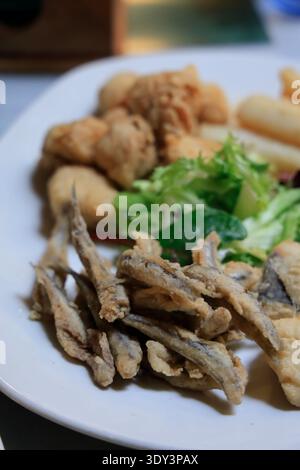 A plate of mixed fried seafood (pescaíto frito) served as a typical tapa dish in a Seville restaurant. Seville, Spain Stock Photo