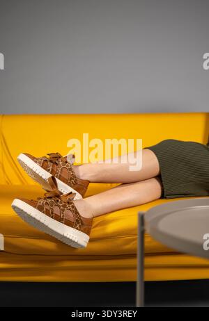 Woman on sofa posing in studio Stock Photo