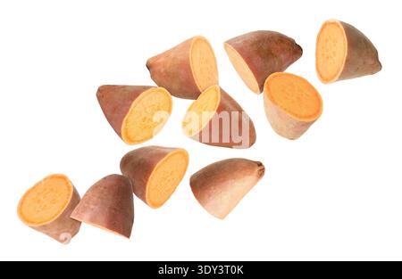 Sweet potato pieces falling against white background Stock Photo