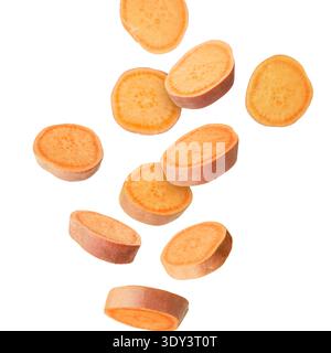 Sweet potato pieces falling against white background Stock Photo