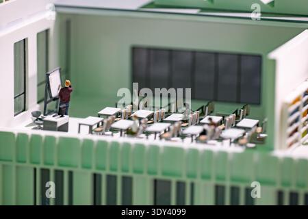 Architectural scale model of a classroom during a lesson with student figurines Stock Photo