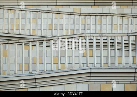 Architectural detail showing abstract geometric patterns, repeating railings, and mosaic facade tiles Stock Photo
