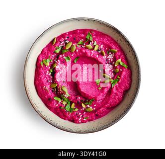 Beetroot hummus decorated with sesame and pumpkin seeds  in bowl  isolated on white background, top view Stock Photo
