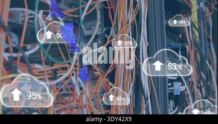 Vertical video: Servers initiating sync, messy cables sending data while cloud UI showing upload % Stock Photo