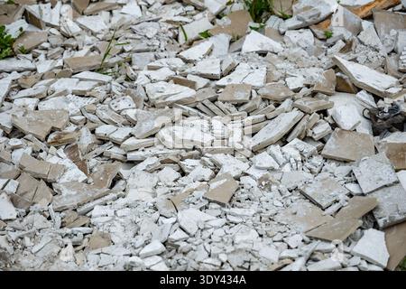 Demolished building materials creating a texture of rubble, waste, and broken fragments Stock Photo