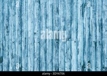 Blue corrugated metal sheet showing weathered surface with rust and peeling paint Stock Photo