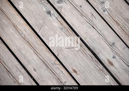 Weathered wooden planks forming abstract diagonal pattern texture with natural grain Stock Photo