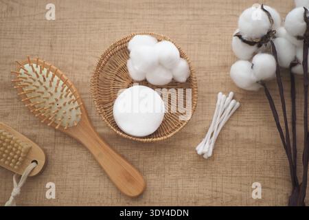 Cotton and grooming items arranged on a wooden table Stock Photo